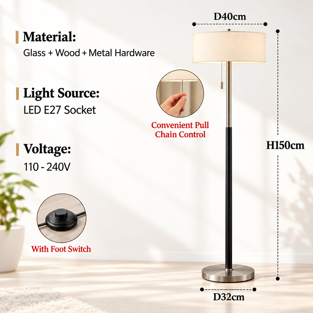A floor lamp product diagram on a white background with text listing material, light source, voltage, and dimensions. The lamp has a white drum shade, black pole and base, and a brushed metallic gold-toned circular base rim.