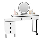 Modern white LED dressing table with a round mirror, 5 drawers, and black metal legs on a plain white background.