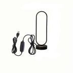 Modern black LED ring bedside lamp with USB cable and inline remote control on a white background.