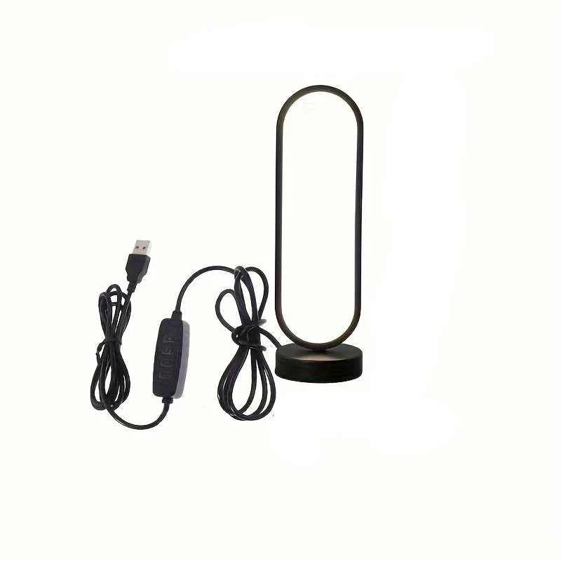 Modern black LED ring bedside lamp with USB cable and inline remote control on a white background.